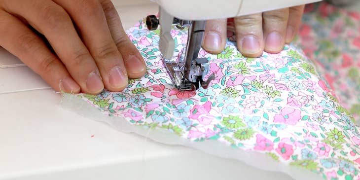Embroidery Machine Operator working with a colorful cloth