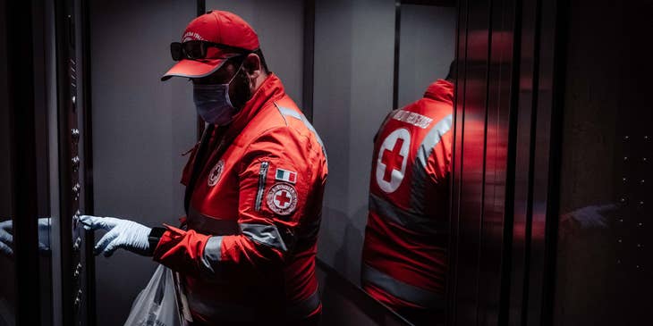 male Emergency Management Specialist pushing the elevator button on the way to emergency headquarters after a day's work