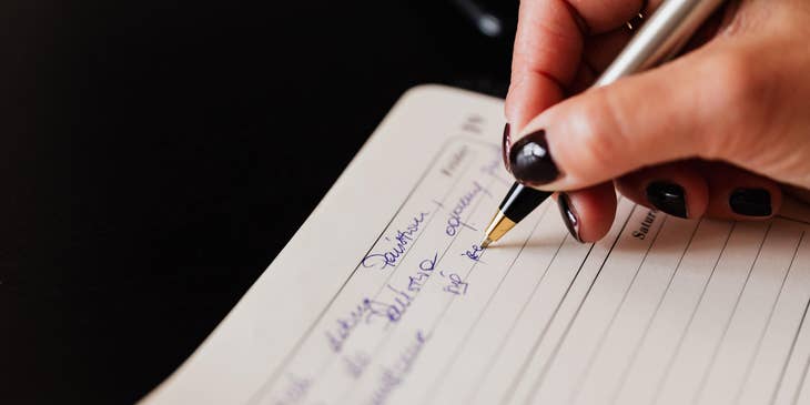 Executive Secretary writing on a schedule book