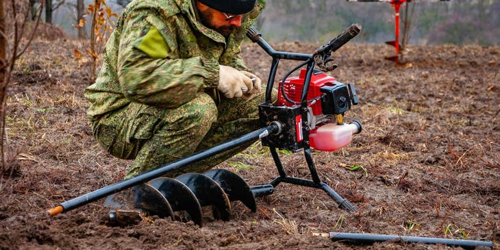 Forestry Technician setting up his equipment before conducting tests in the surrounding area