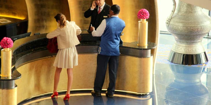 Front Desk Agent assists a guest who left her room keys.