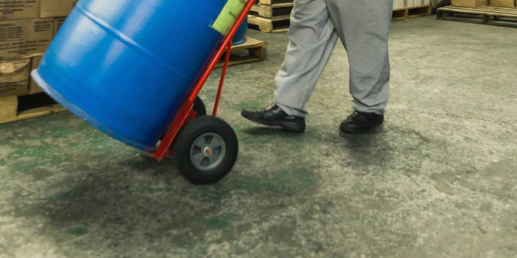 A Fulfillment Associate in a warehouse moving newly delivered merchandise to the designated storage area.