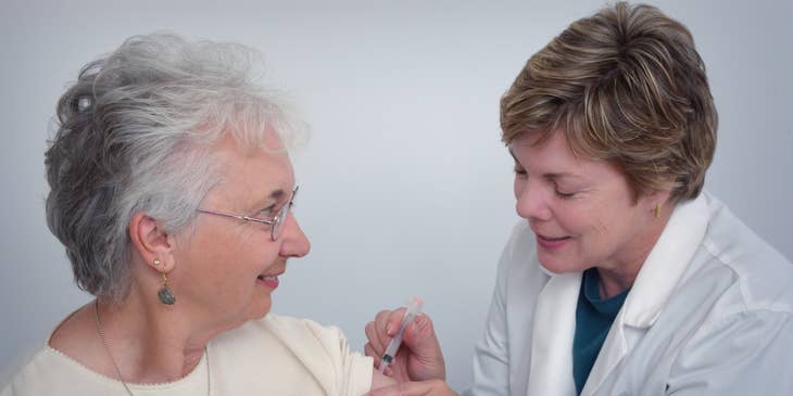 Geriatric Physician administering an intramuscular injection to an elderly.