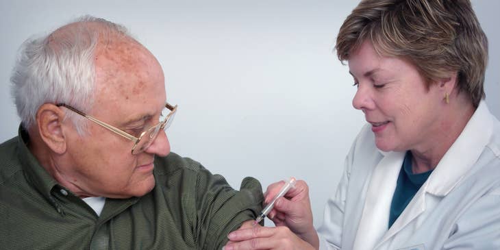 Geriatrician administers vaccine to the elderly.