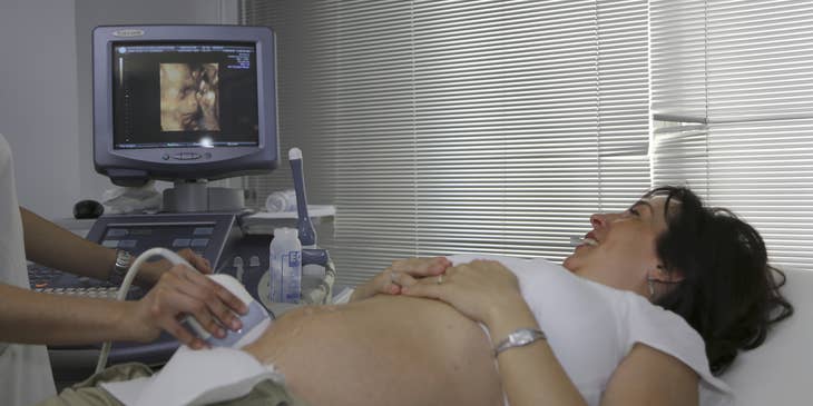 Gynecologist performing an ultrasound to a first time mom.