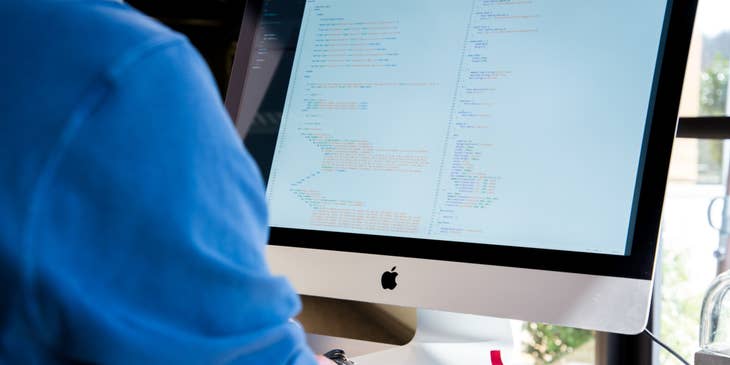 Hadoop Developer working on an application while sitting at his workstation