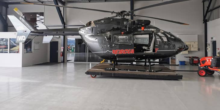 black helicopter parked in a garage