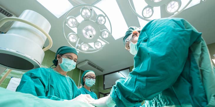 Hepatologist conducting liver transplant to an old patient.