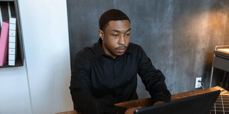 An HR Representative working on his laptop and taking notes.