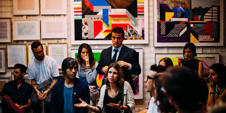 A Human Rights Advocate in a suit attending a human rights meeting to observe and gather information on people's interest.