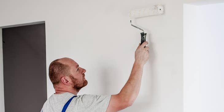 Industrial Painter painting an interior wall