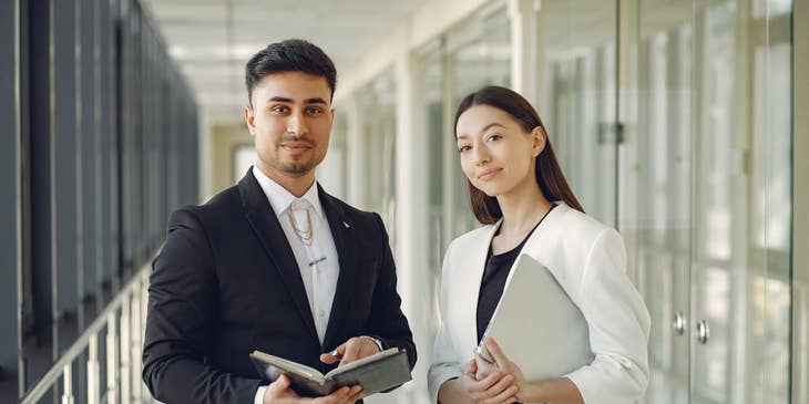 two IT Consultants standing in the hallway to meet their clients and present their recommendations