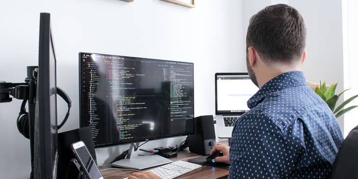 IT Engineer monitoring the network system of the company at his workstation