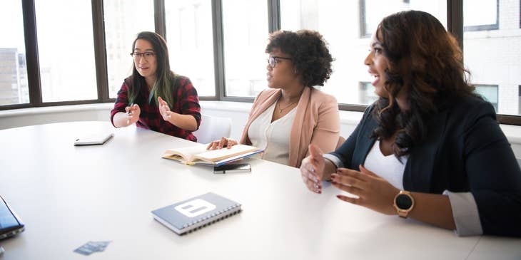 female IT Project Manager discussing with her team the details of a new project for the company