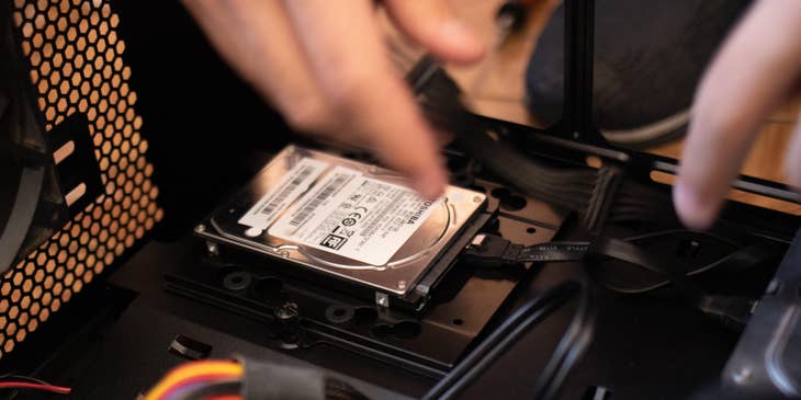 IT Specialist installing a hard disk on one of his client's workstations