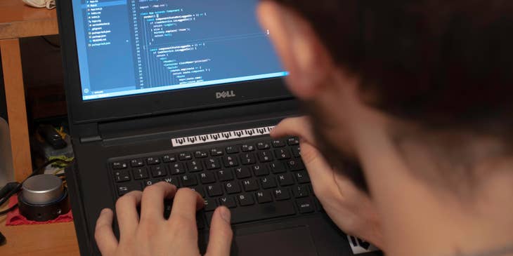JavaScript Developer finalizing the software design on his laptop