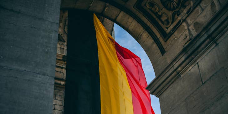 Belgium flag hanging in an archway.