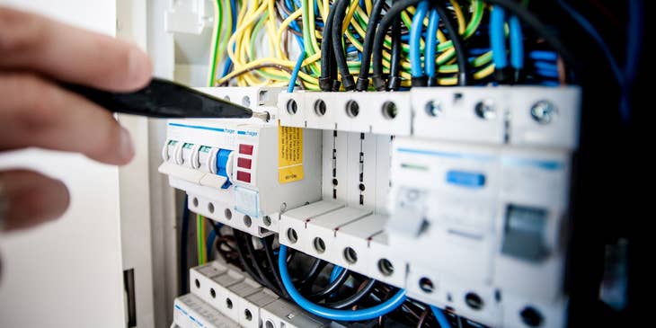 Journeyman electrician repairing a panelboard