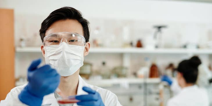 Lab assistant wearing safety gear running tests