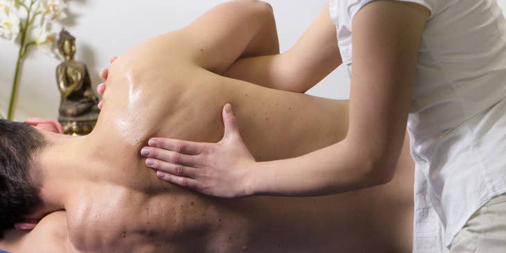 Licensed massage therapist performing a deep-tissue massage.