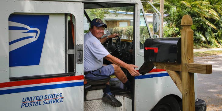 Postman sitting in postal truck.