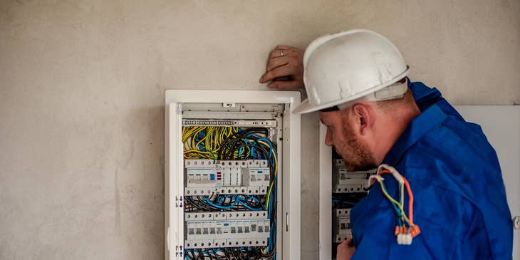 Maintenance Electrician repairing a building's electric panel box