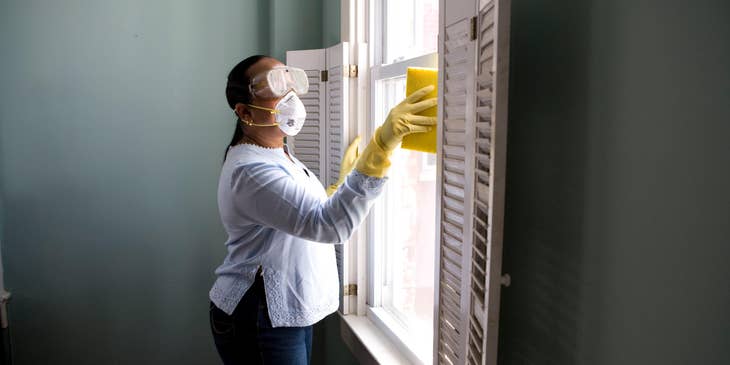 Maintenance Supervisor making sure that a window glass is properly cleaned