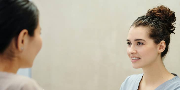 Medical office assistant greeting a patient