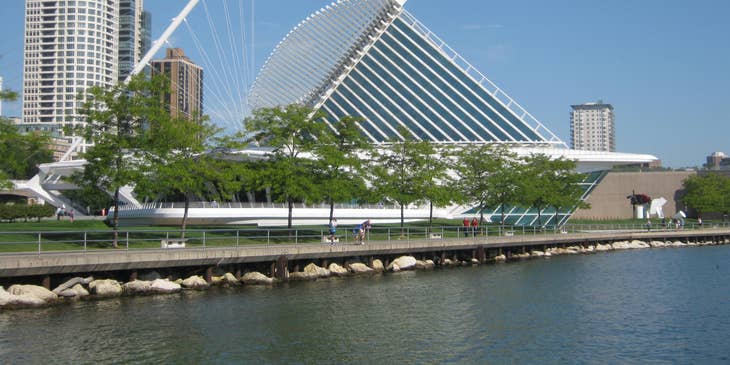 A waterside scene of buildings and greenery in Milwaukee, Wisconsin.