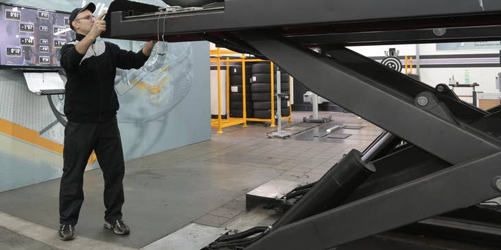 MOT tester checking on a black sedan