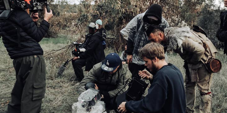 the director and movie producer checking the footage from a movie set