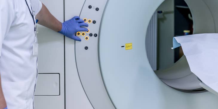 MRI technician maneuvering the MRI equipment.