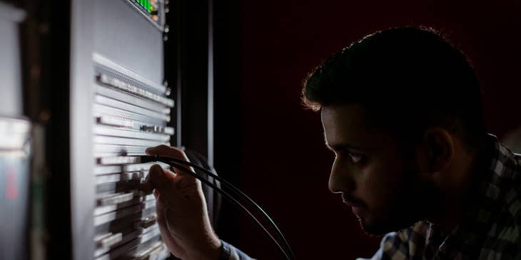 NOC technician looking into a server at the data center