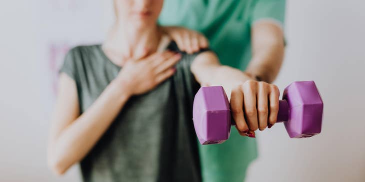 Occupational therapist assisting the client in a physical rehabilitation program.