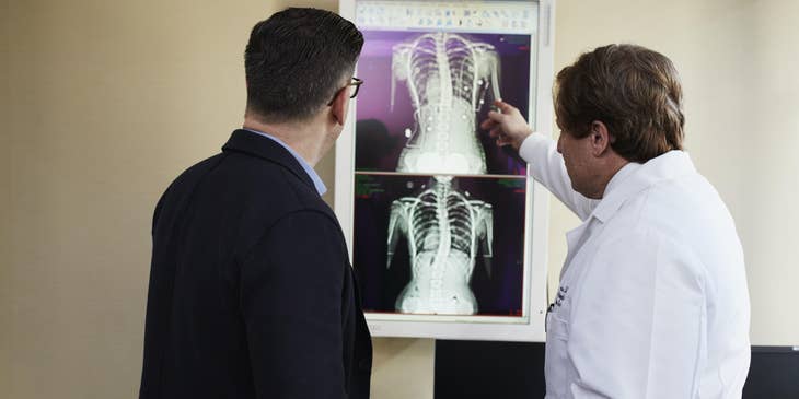 Pediatric geneticist explaining lung condition to the patient's patient while showing Xray results.