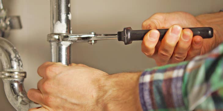 Plumber fixing a pipe