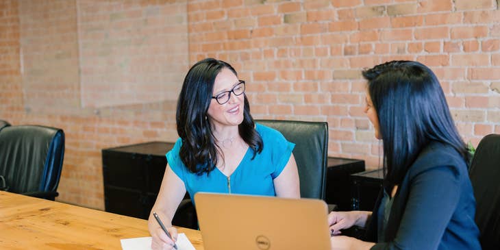 Public relations assistant taking notes while her superior is discussing fresh ideas for a new marketing content