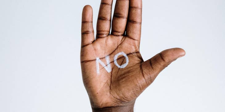 Hand with the word no written on it.