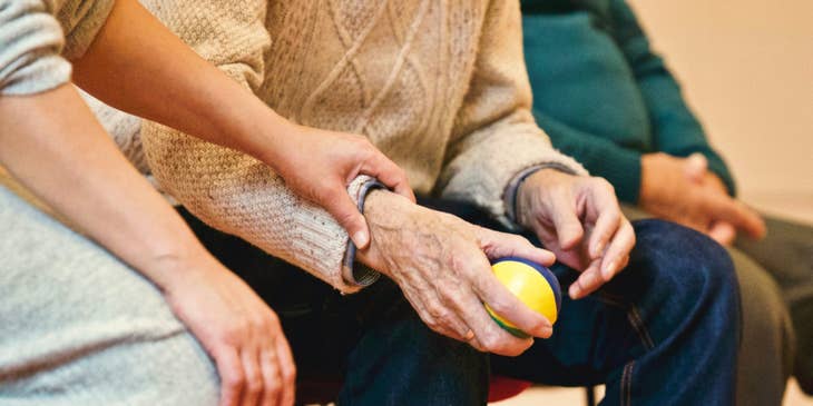 Residential Counselor holding the hand of one of the residents while sitting on a bench