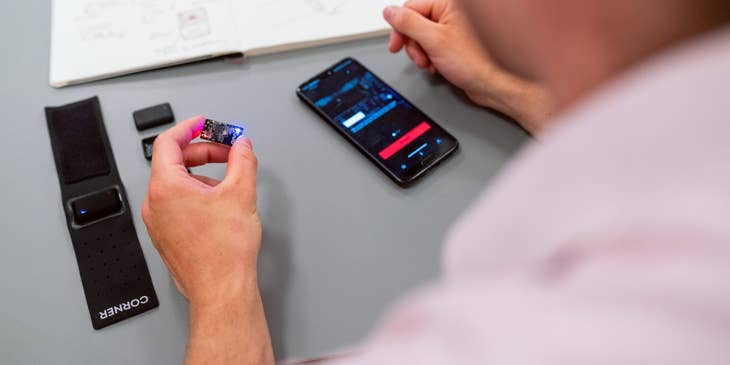 RF Engineer holding a microchip to be inserted on a mobile phone