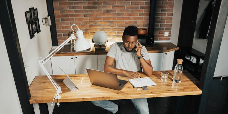 Sales Account Executive on the phone setting up a meeting with a client to further discuss the clients' needs