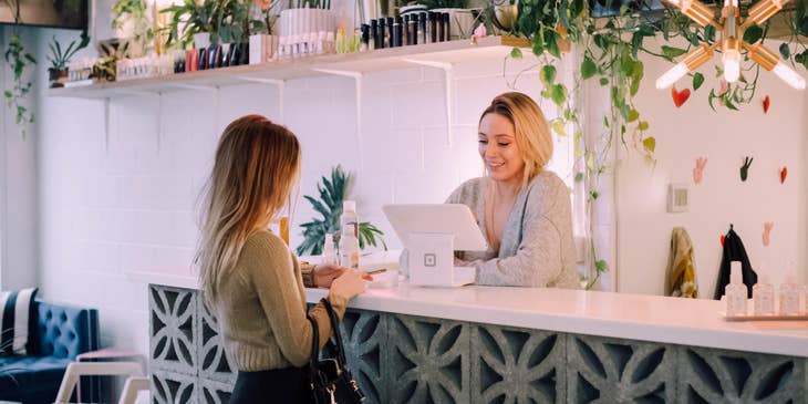 Salon Receptionist issuing the receipt for the services as well as the product she bought