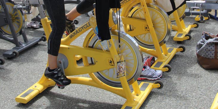 women in a spin class being taught by an instructor