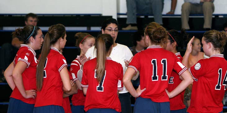 a woman coaching a volleyball team