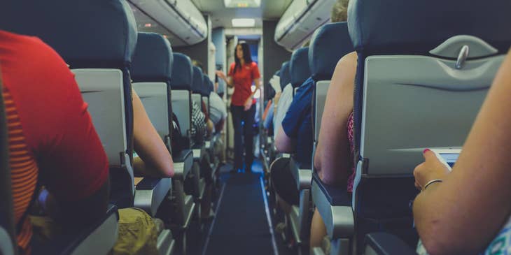 A stewardess explaining safety procedures to passengers.