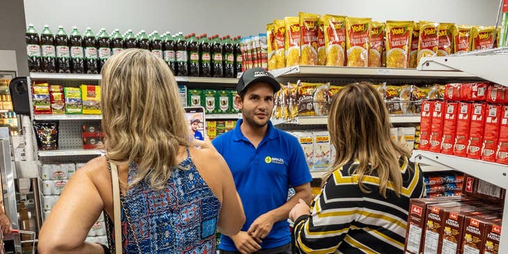 Store clerk answering customers questions about certain products