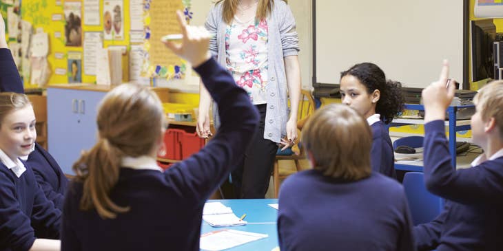 Substitute teacher listens to her students' questions during class