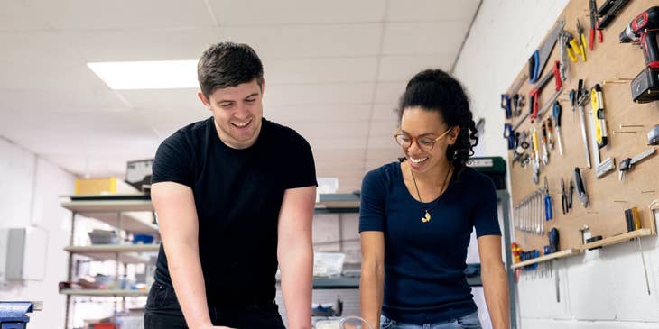 female Technical Engineer showing the product's test results to her colleague in a workshop