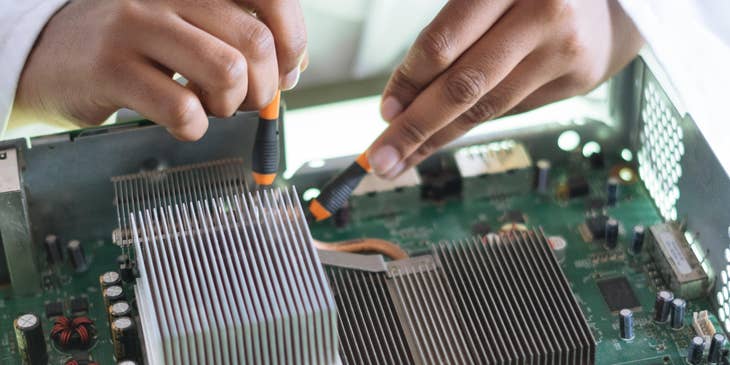 A test analyst checking on the functionality of a computer.