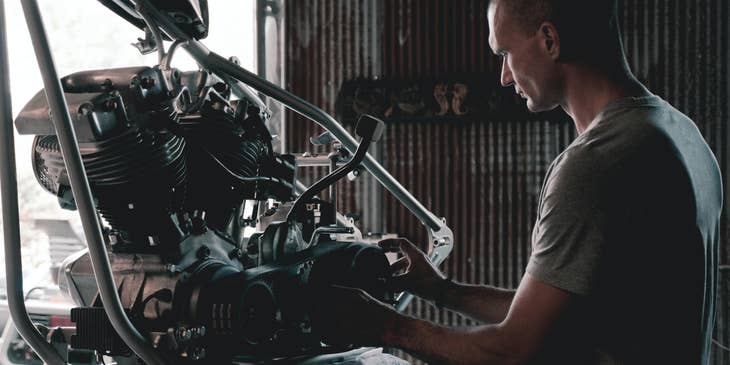 Trailer mechanic working on an engine